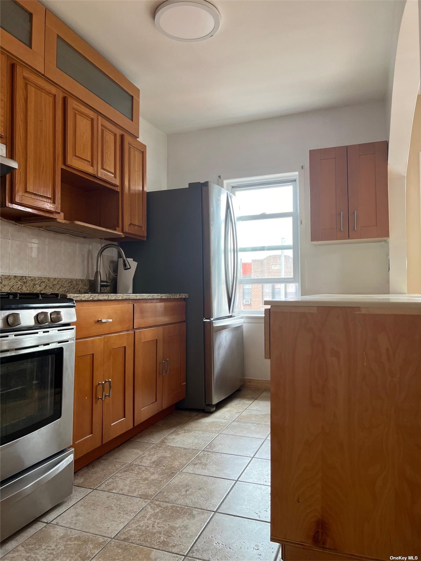 a kitchen with appliances cabinets and a window