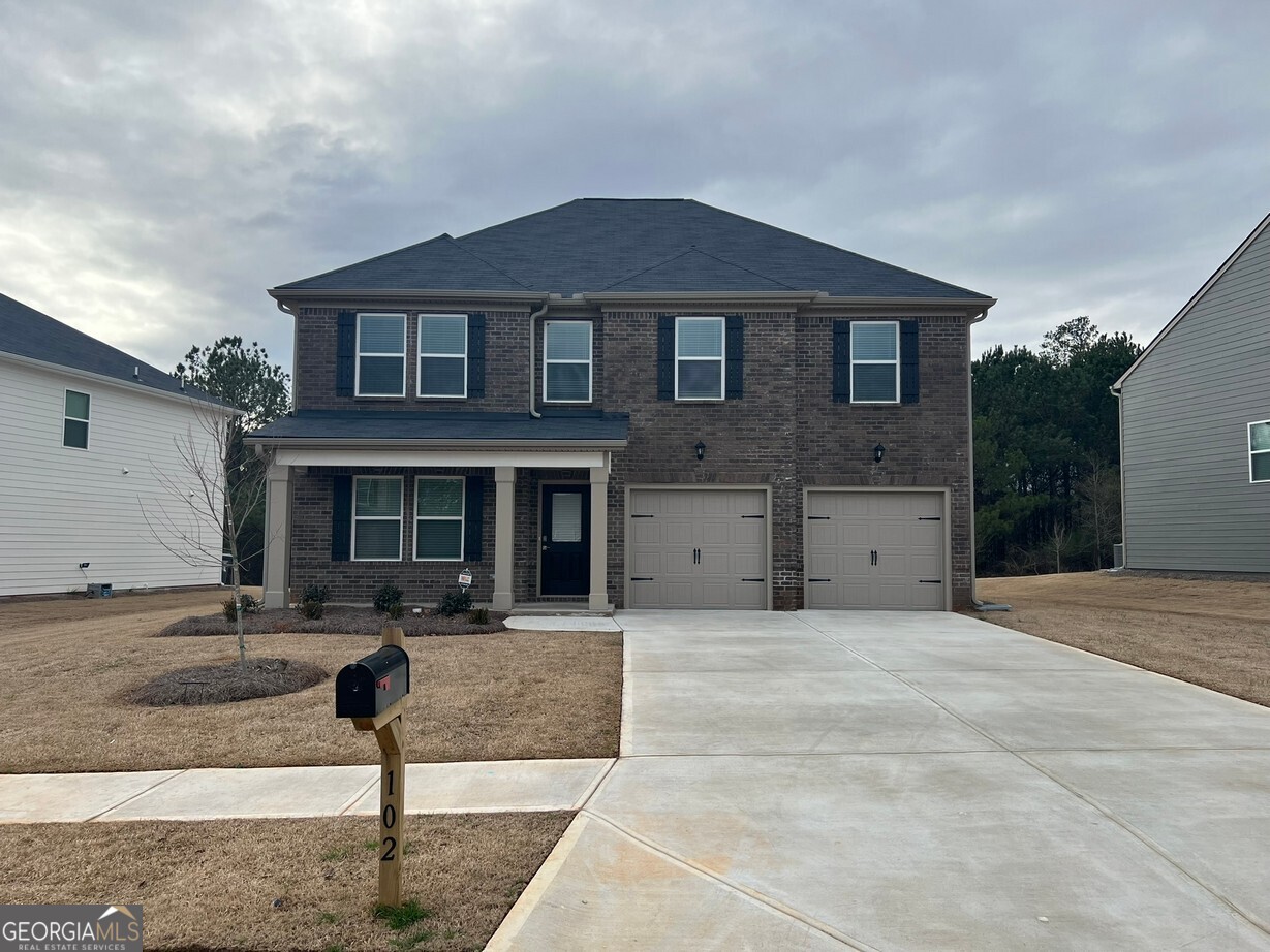 a front view of a house with garage