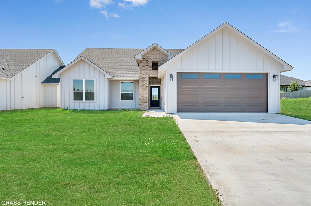 a front view of house with yard and garage