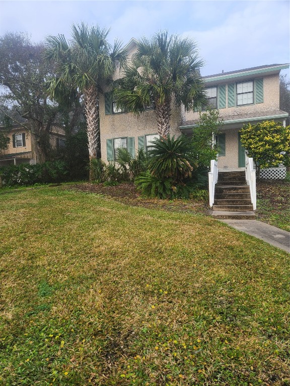 a view of a house with a yard and plants