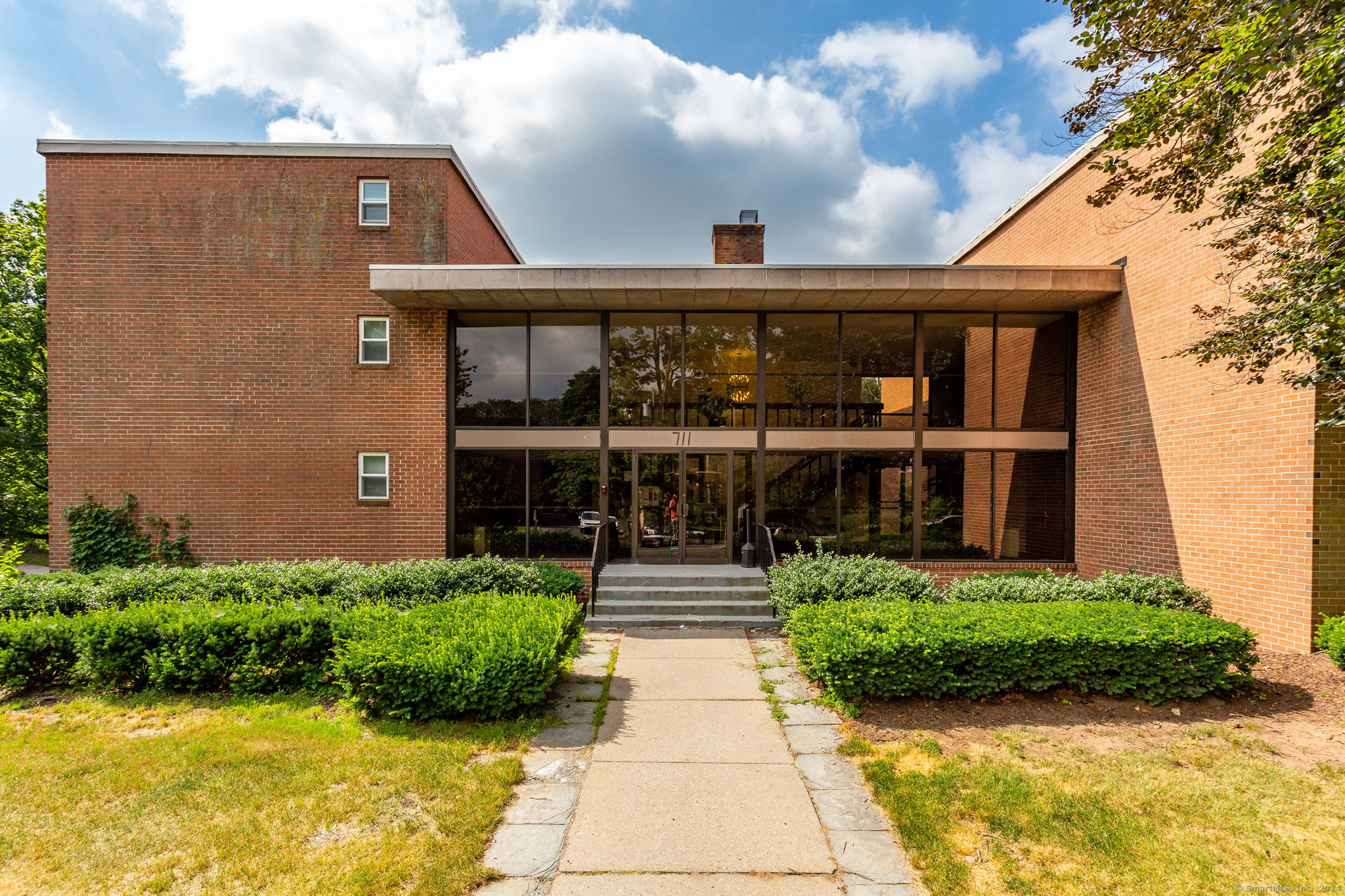 a front view of a house with garden