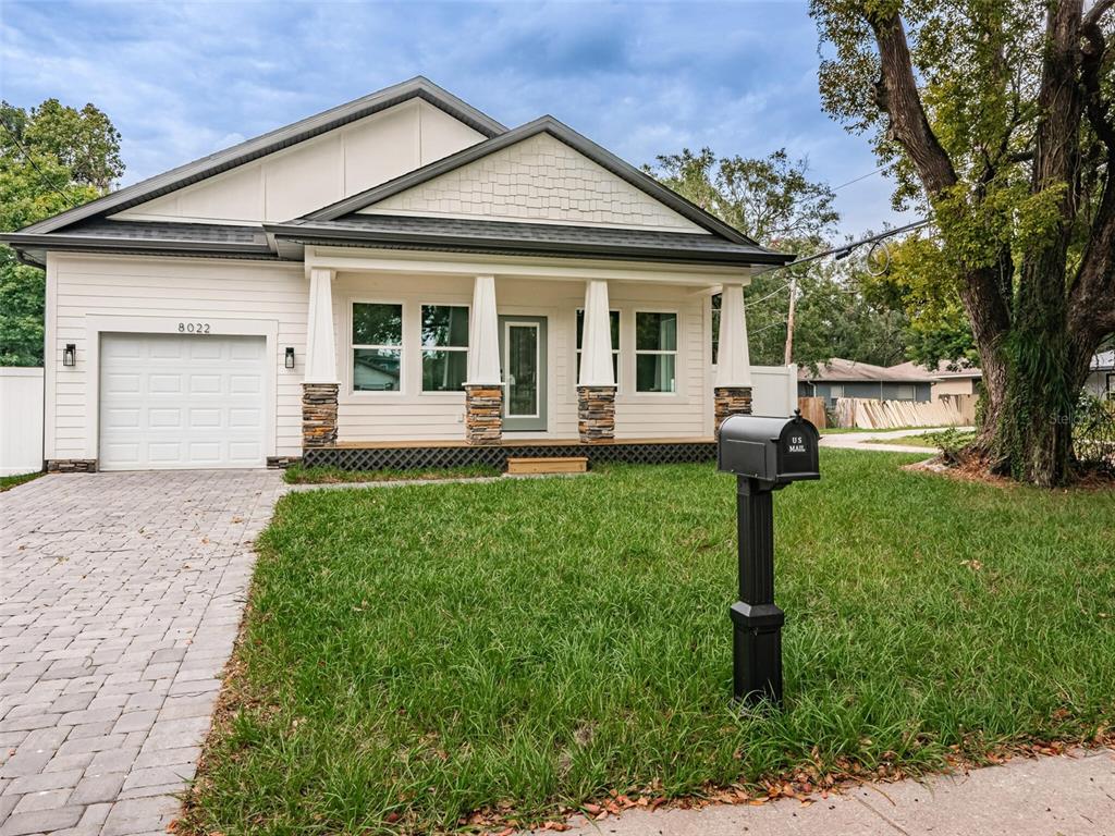 a front view of a house with a yard and porch