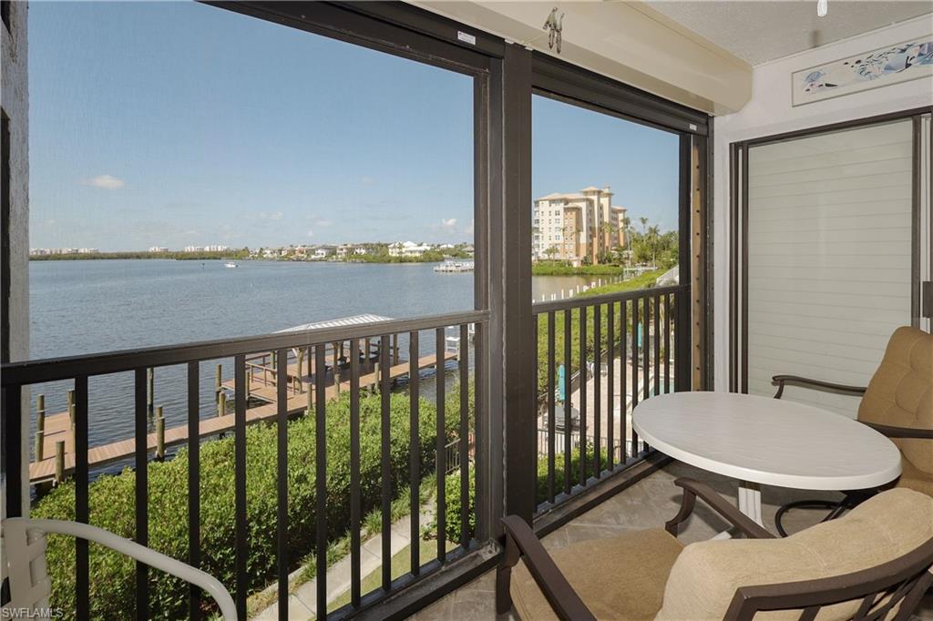 a view of a balcony with chair and wooden floor