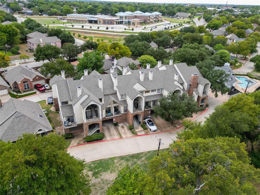 an aerial view of residential houses with outdoor space and street view