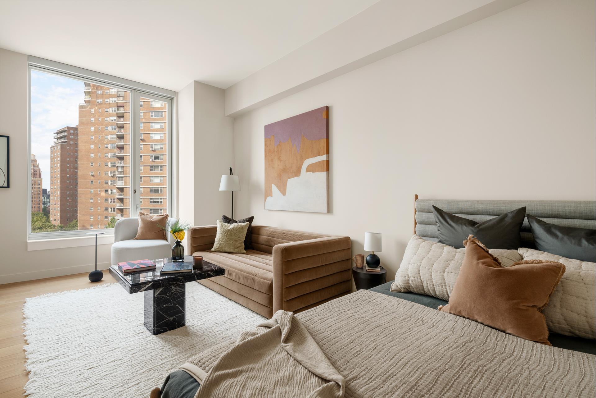 a bedroom with furniture and large windows