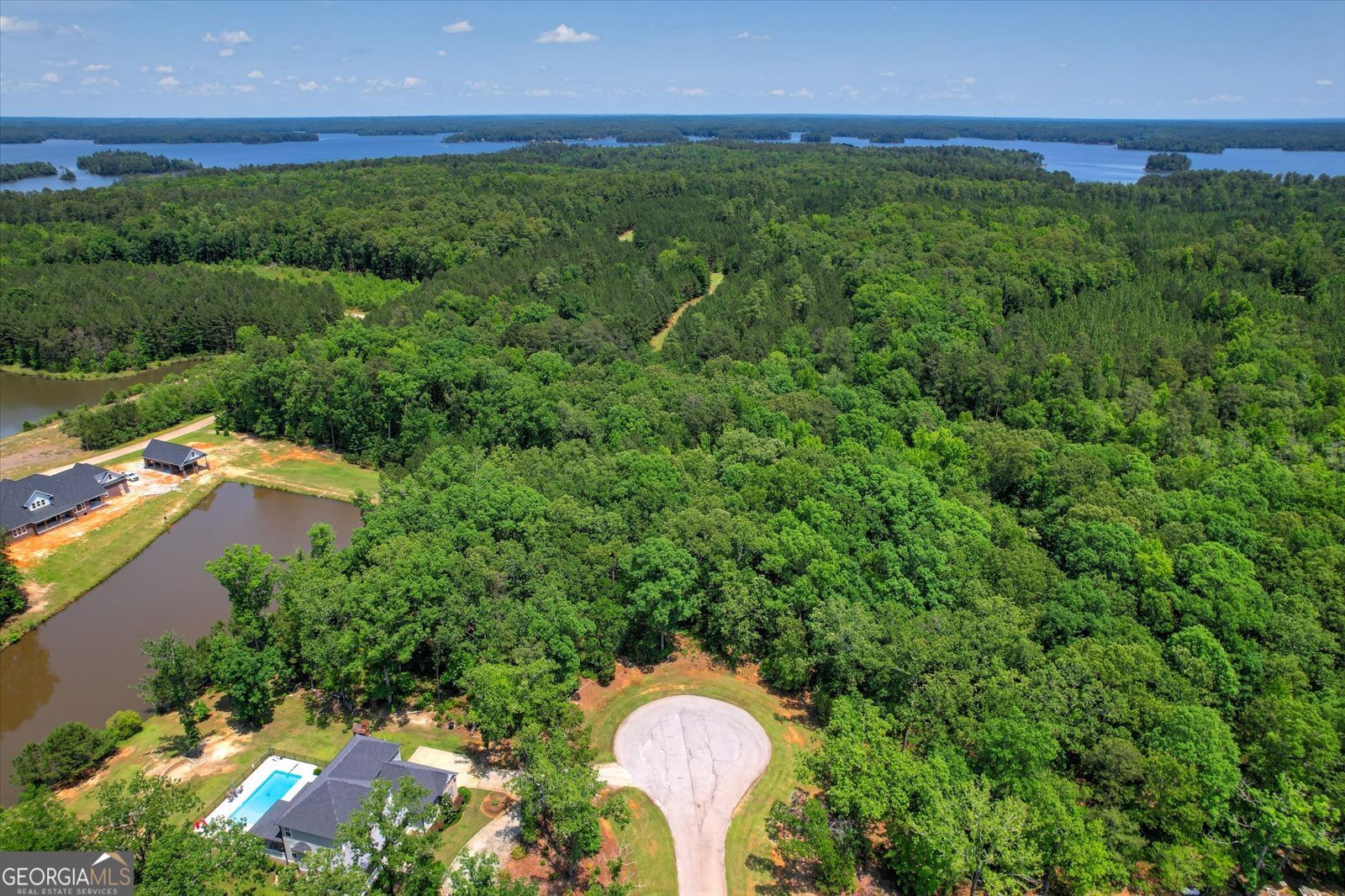 a aerial view of a house with a yard and lake view