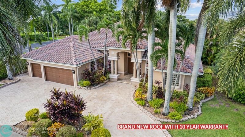 a aerial view of a house with a yard and potted plants