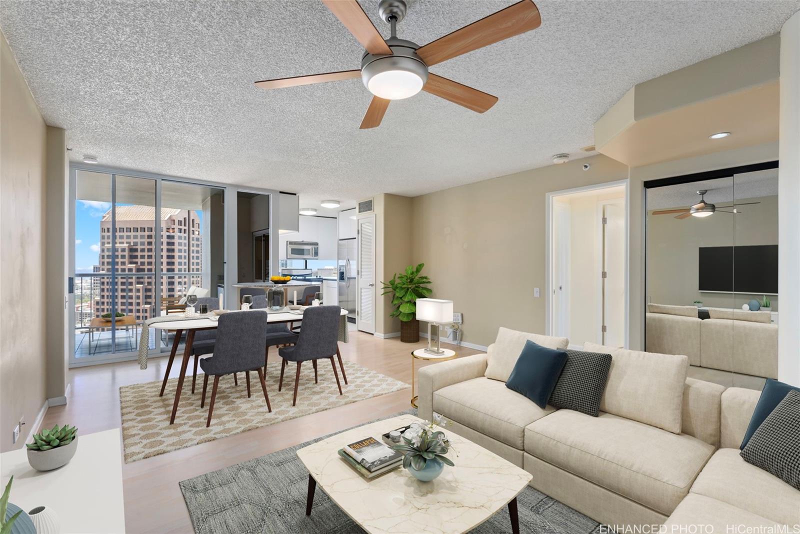 a living room with furniture kitchen view and a large window