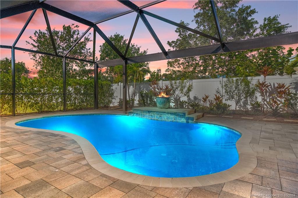 a view of swimming pool with a patio and a yard