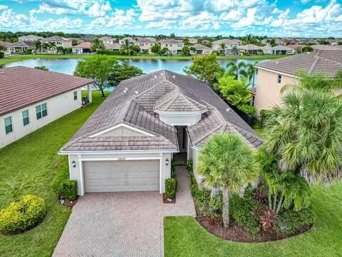 an aerial view of a house with a yard and potted plants