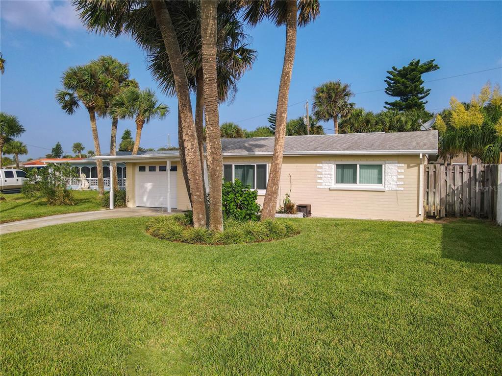 a front view of a house with a garden