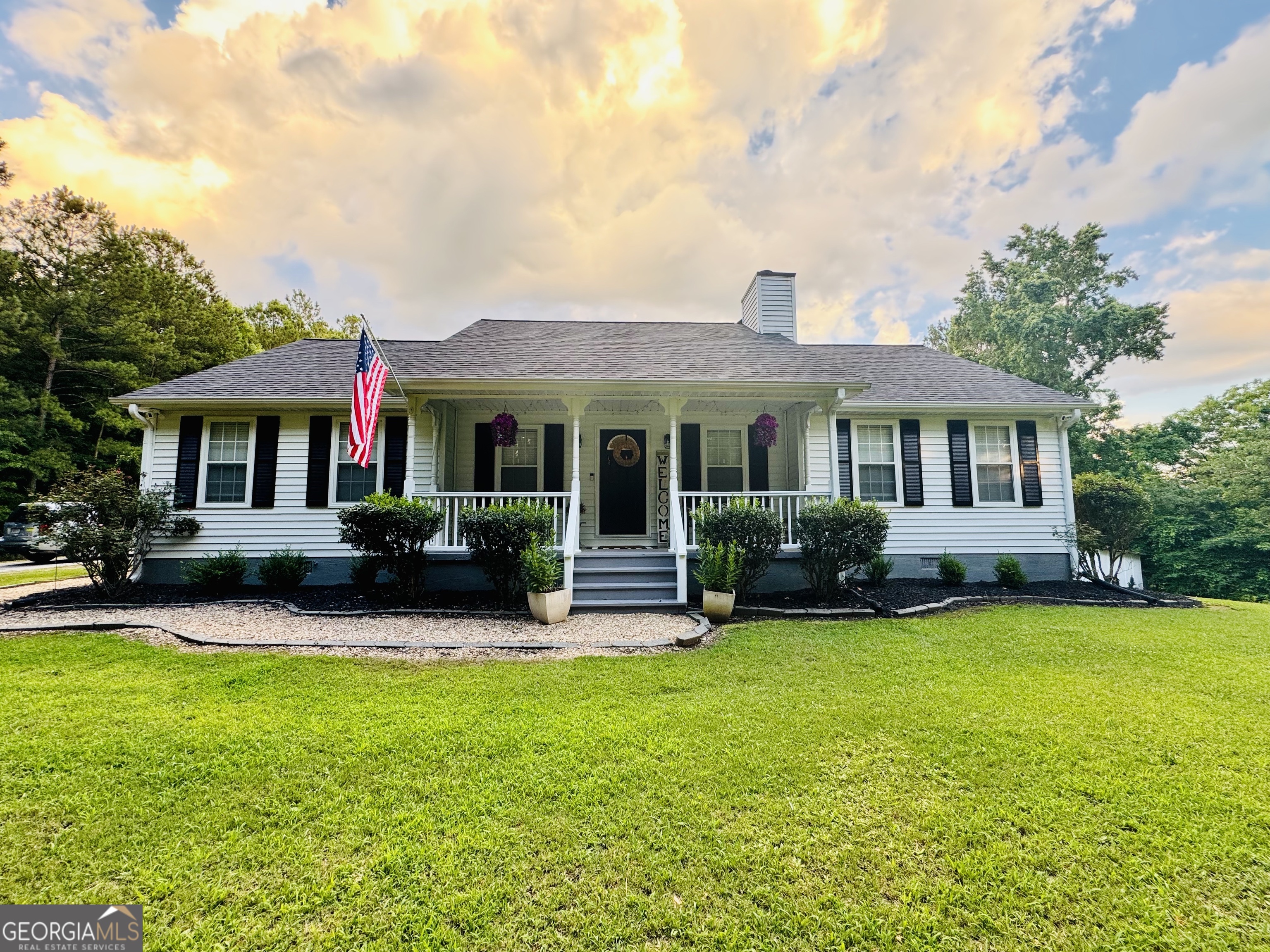 a front view of a house with a garden and porch