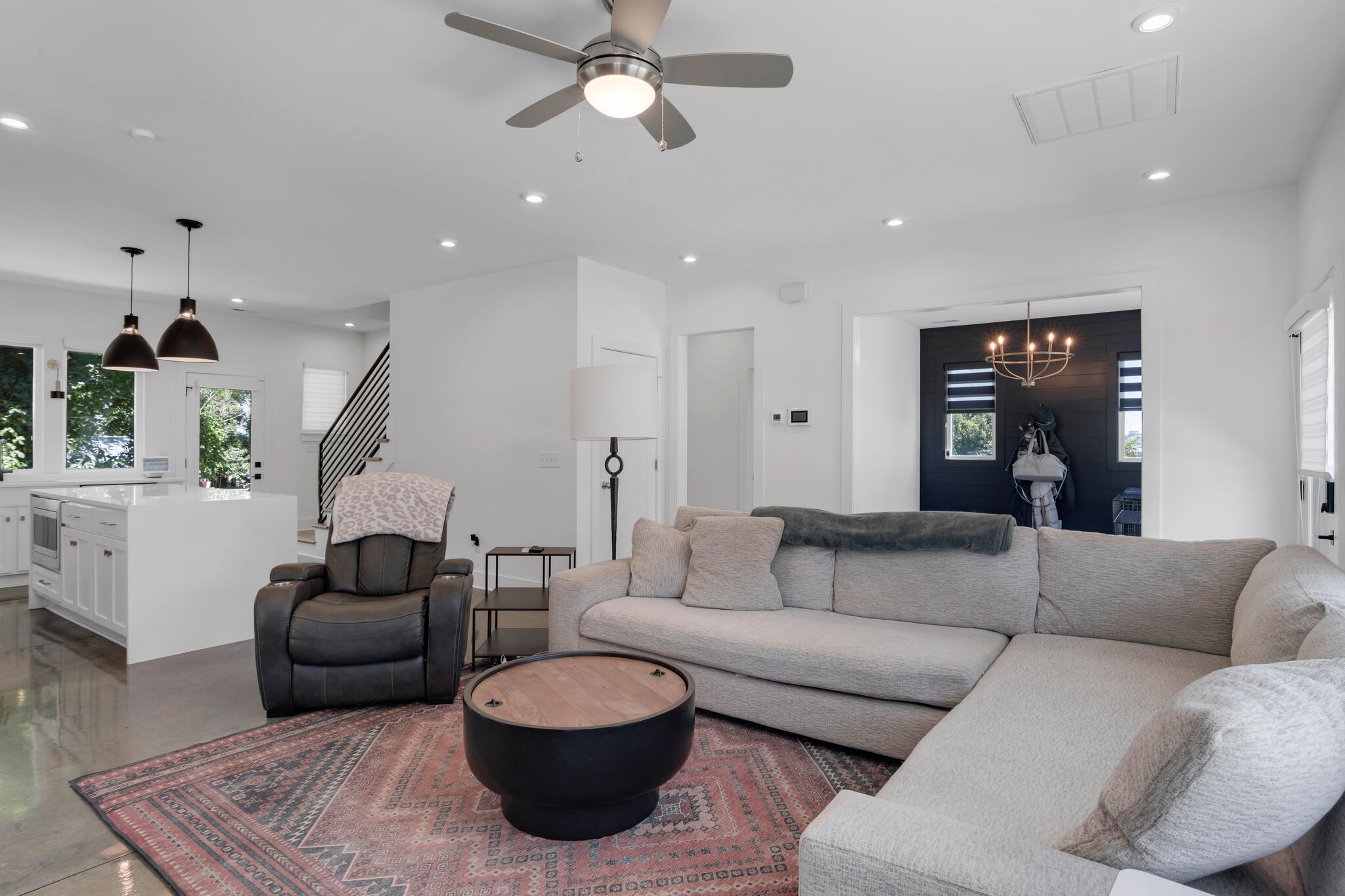 a living room with furniture and a chandelier