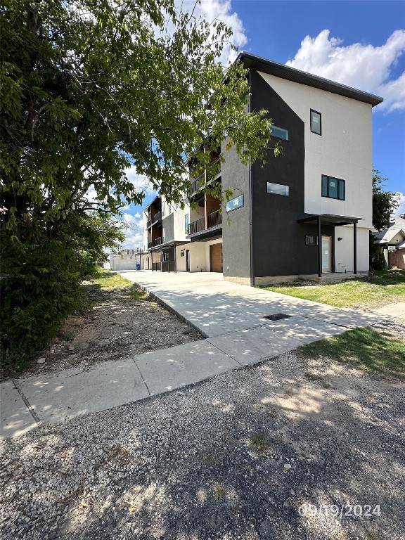 a view of a house with a yard and tree