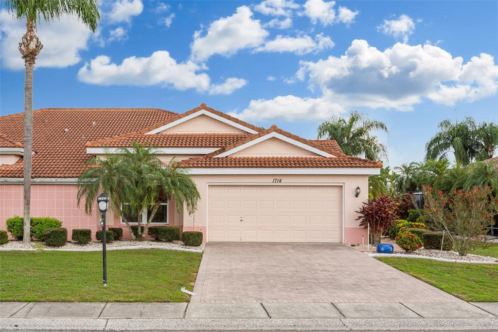 a front view of a house with a yard and garage