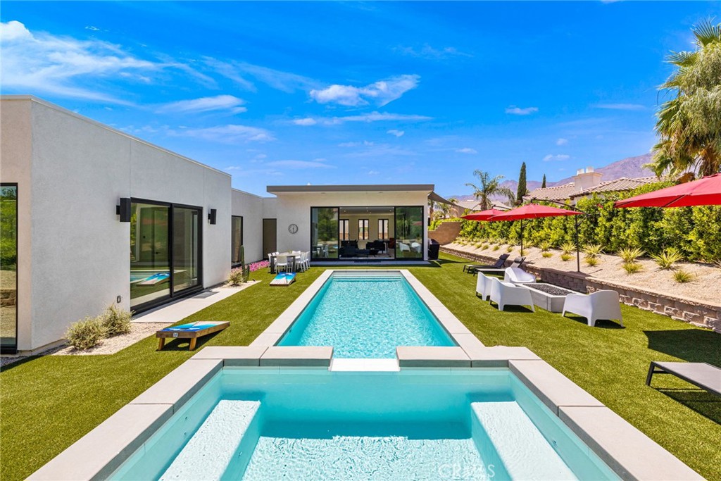 a view of swimming pool with seating area and furniture