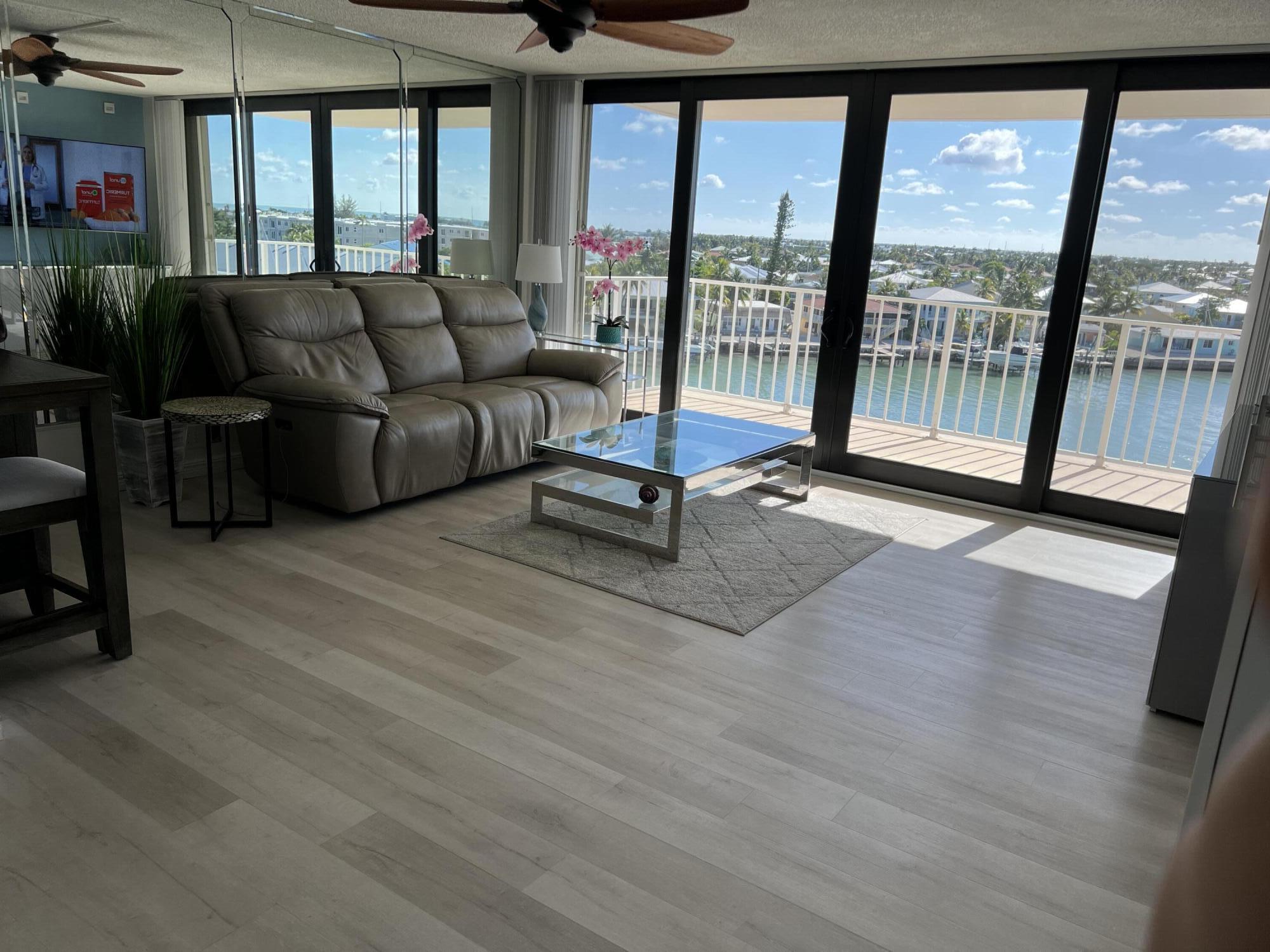 a living room with furniture and a floor to ceiling window