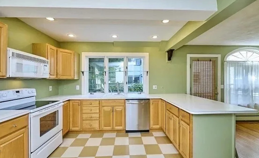 a kitchen with a sink and a stove top oven