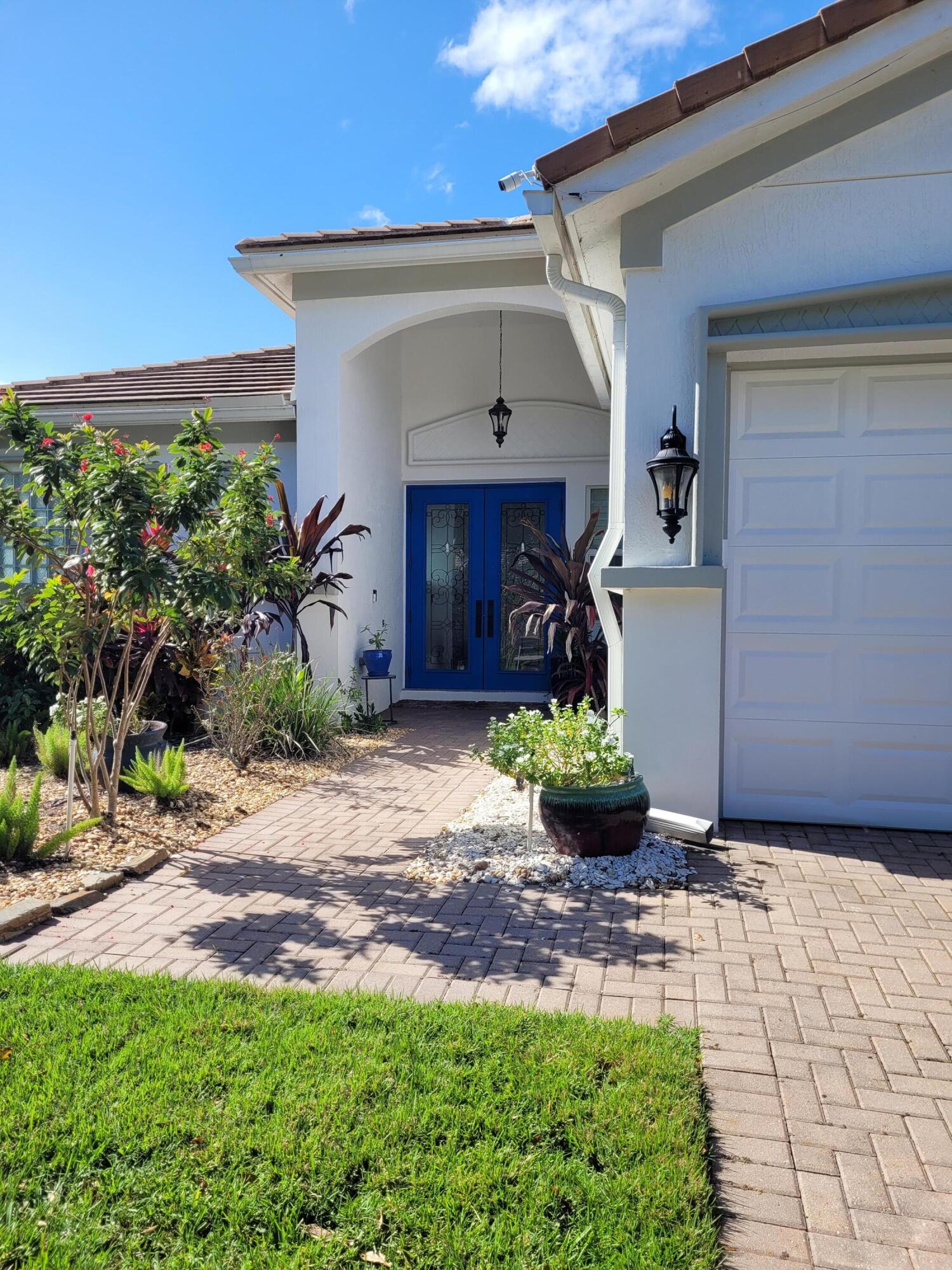 a front view of a house with garden