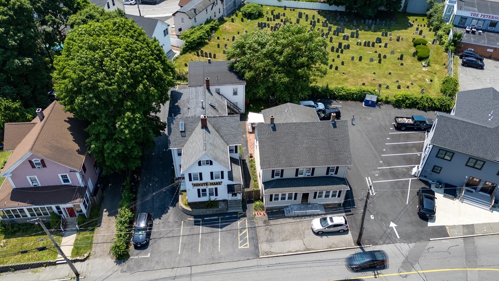 an aerial view of a house with garden space and street view