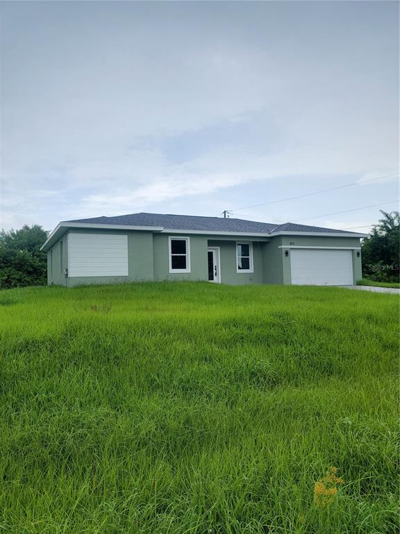 a front view of house with a garden