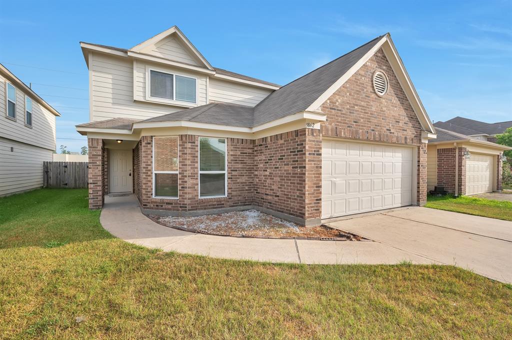 a front view of a house with a yard and garage