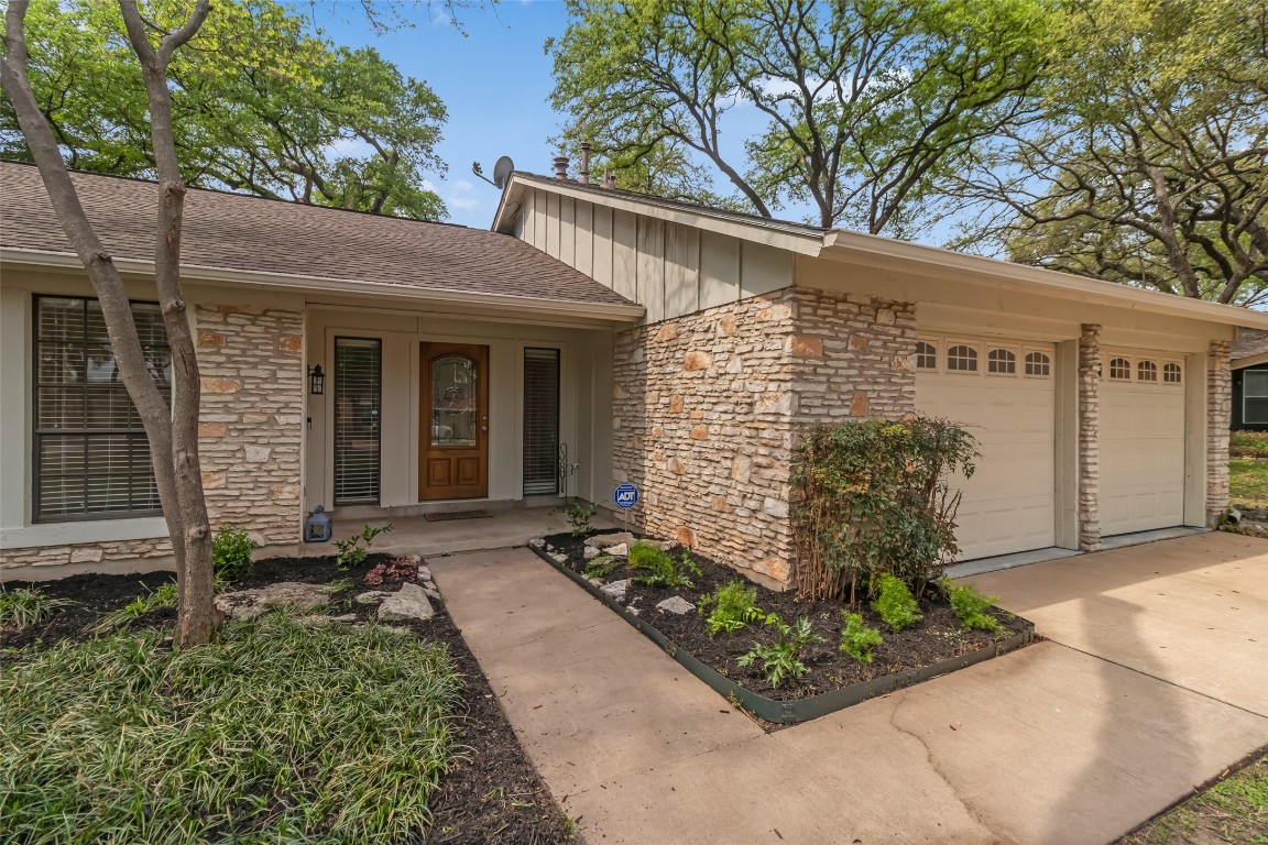 a front view of a house with garden