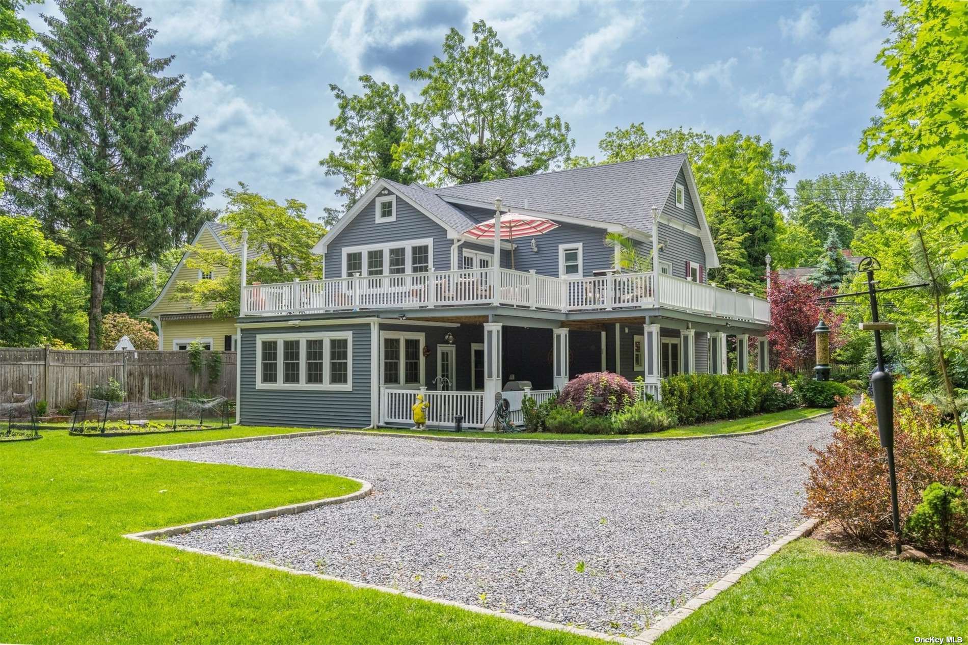 a front view of a house with a garden and plants