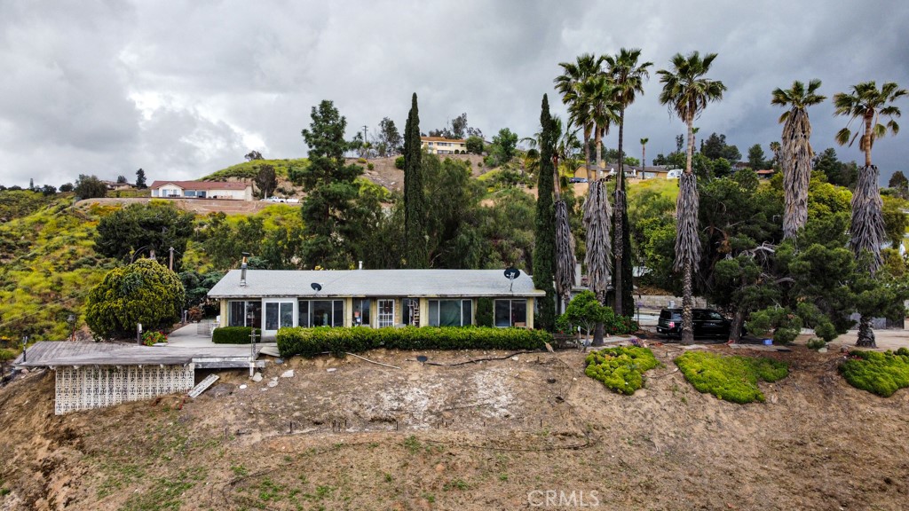 a view of a house with a yard and sitting area