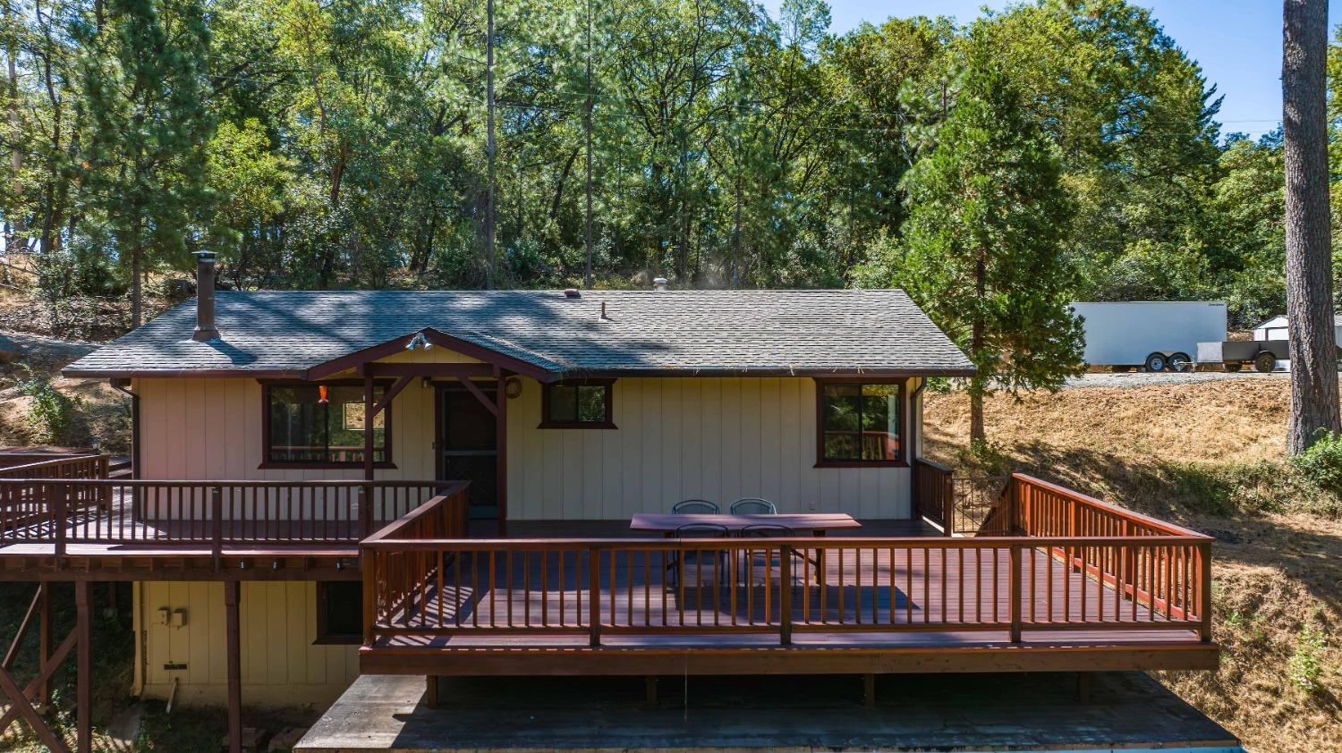 a view of a house with wooden deck and a sink