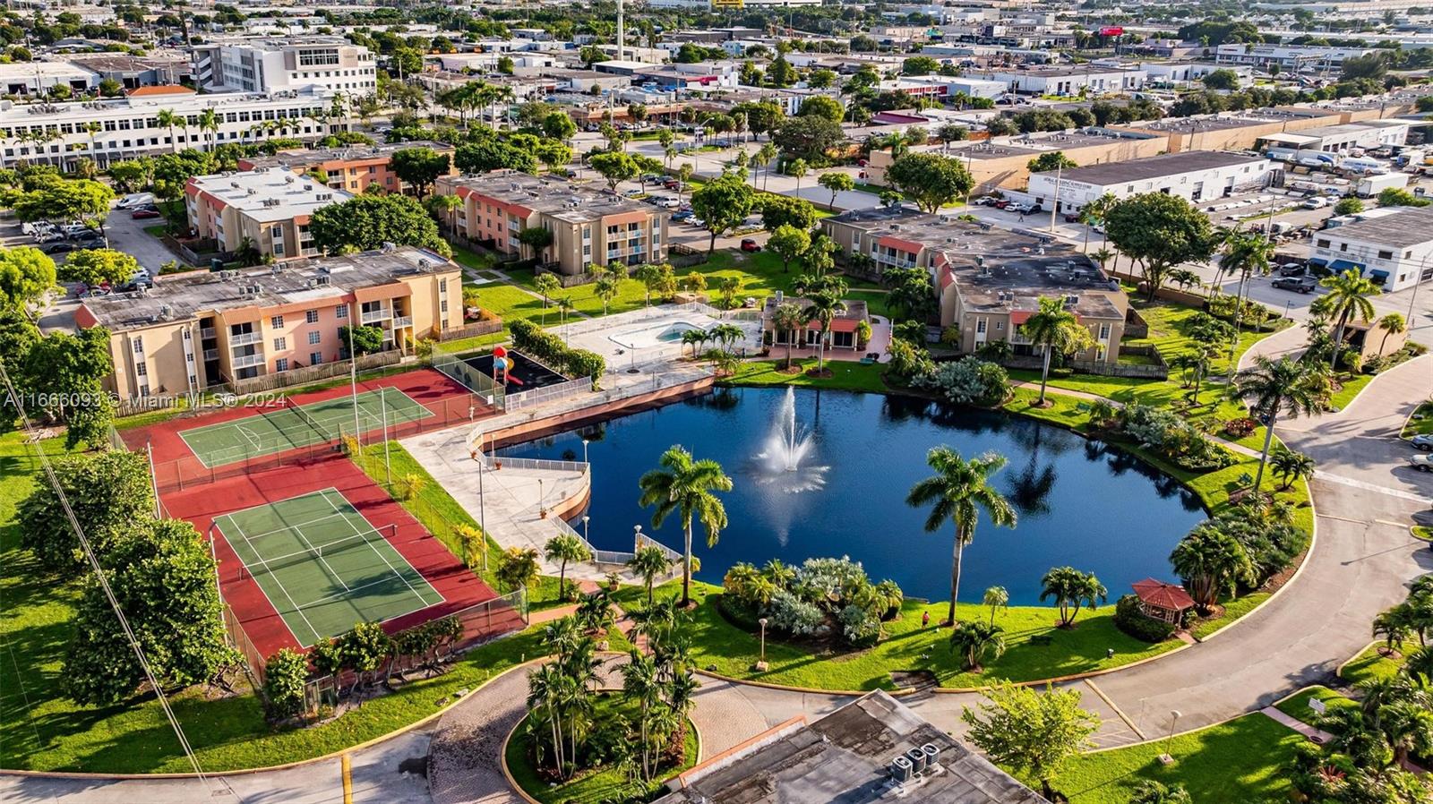 an aerial view of residential houses with outdoor space and swimming pool