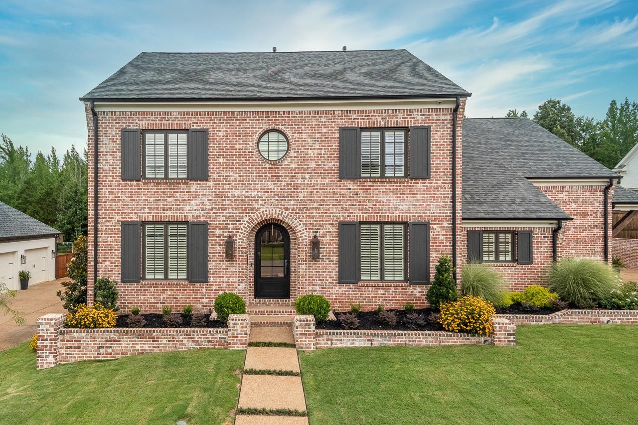 a front view of a house with a yard