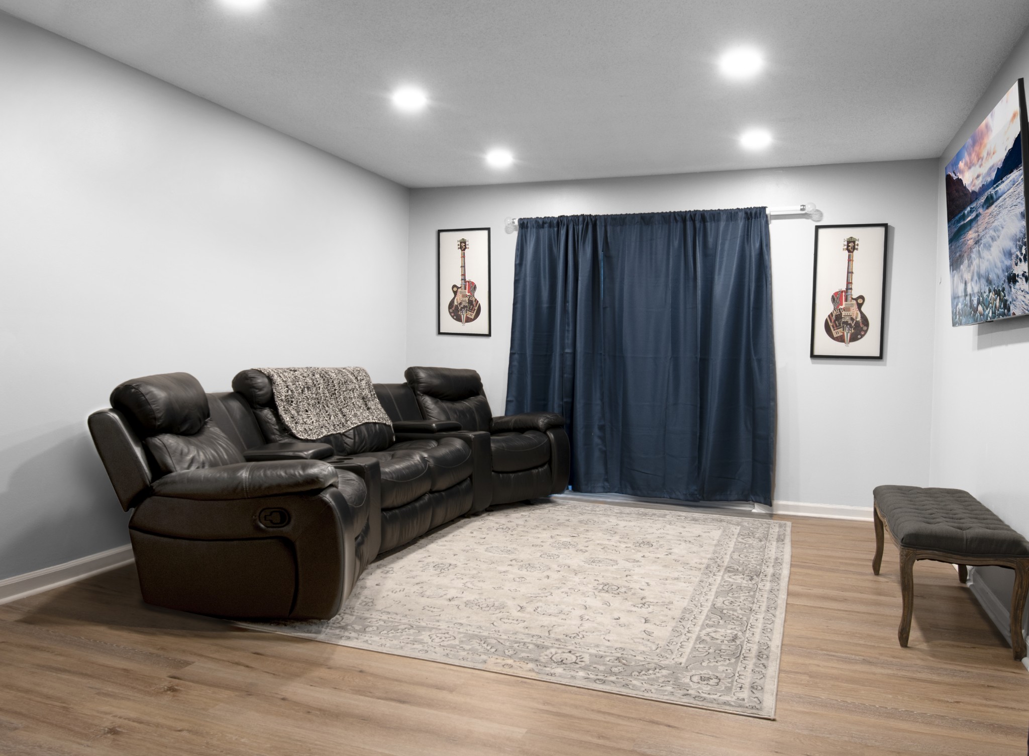 a living room with furniture and a wooden floor