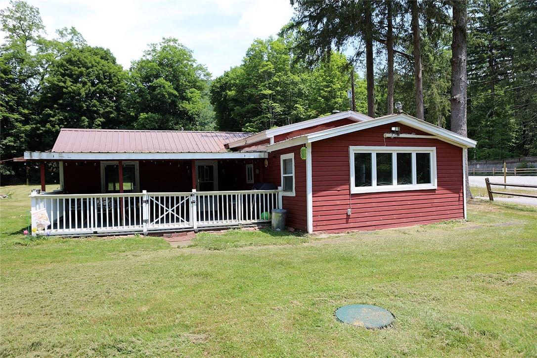 Ranch-style home featuring a front lawn and a porch