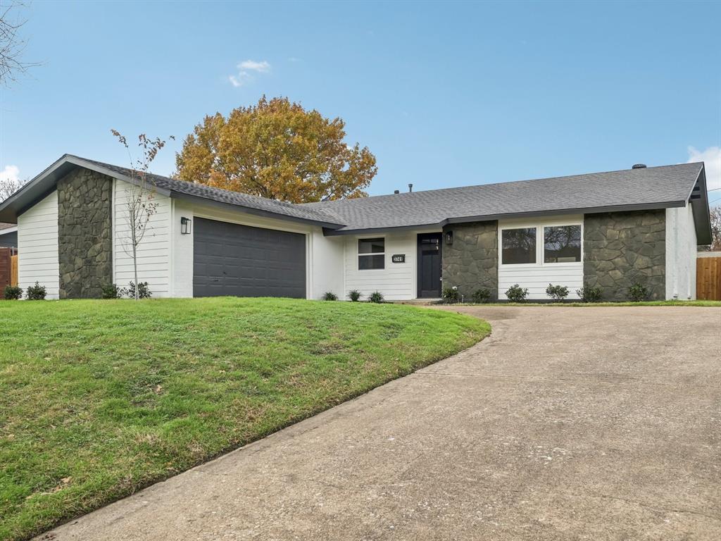 a front view of house with yard and green space