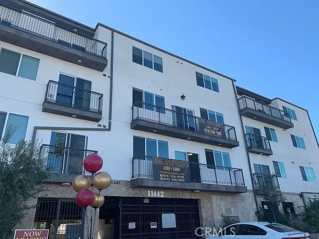 a front view of building with an outdoor space and seating