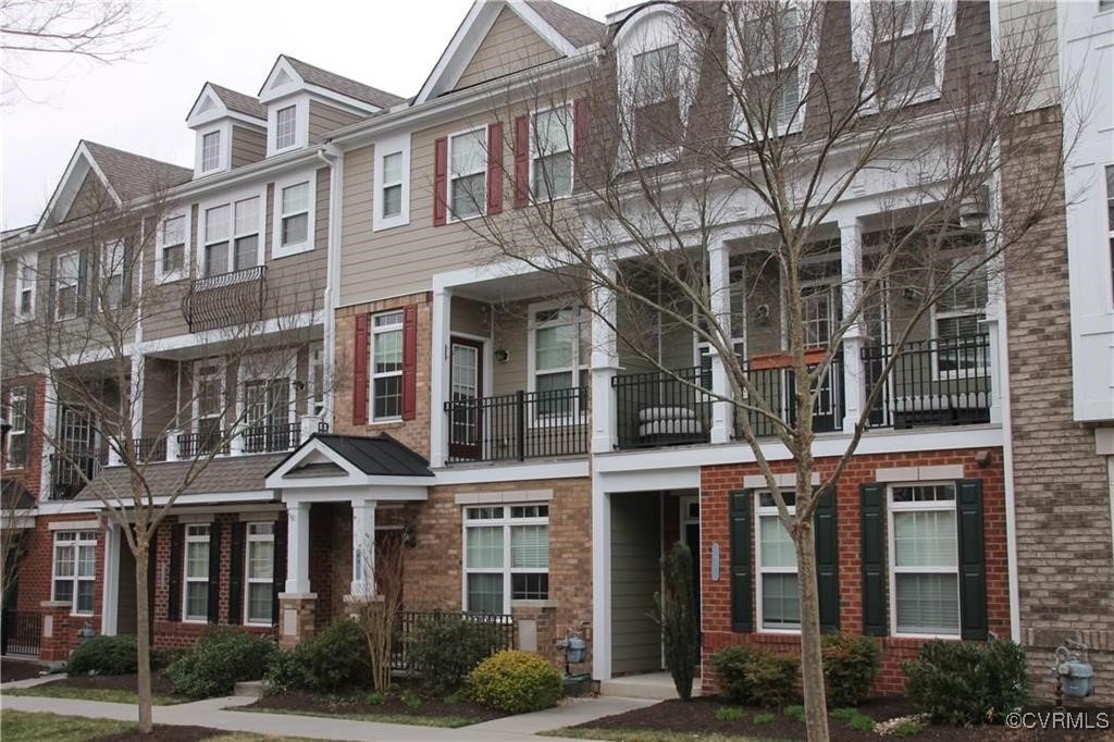 a front view of a residential apartment building with a yard