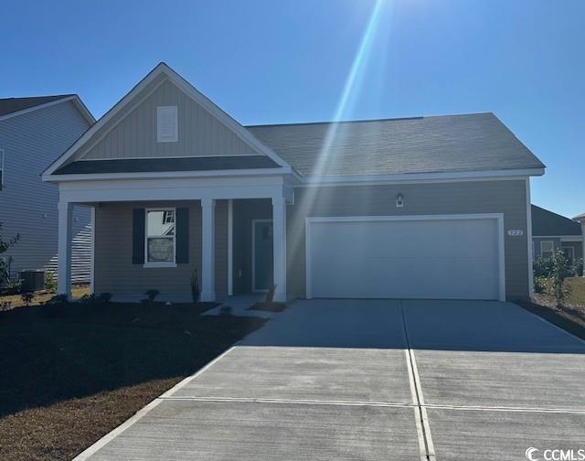 View of front of house with a porch and a garage