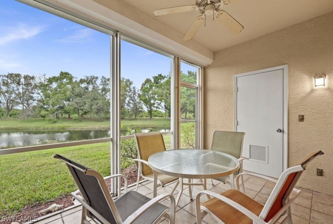 a view of a porch with furniture and a yard