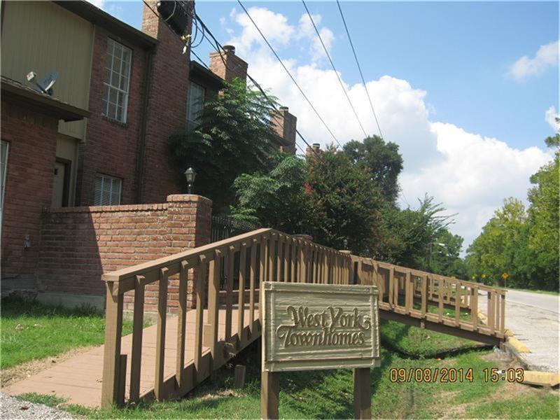 a view of a wooden house with a small yard