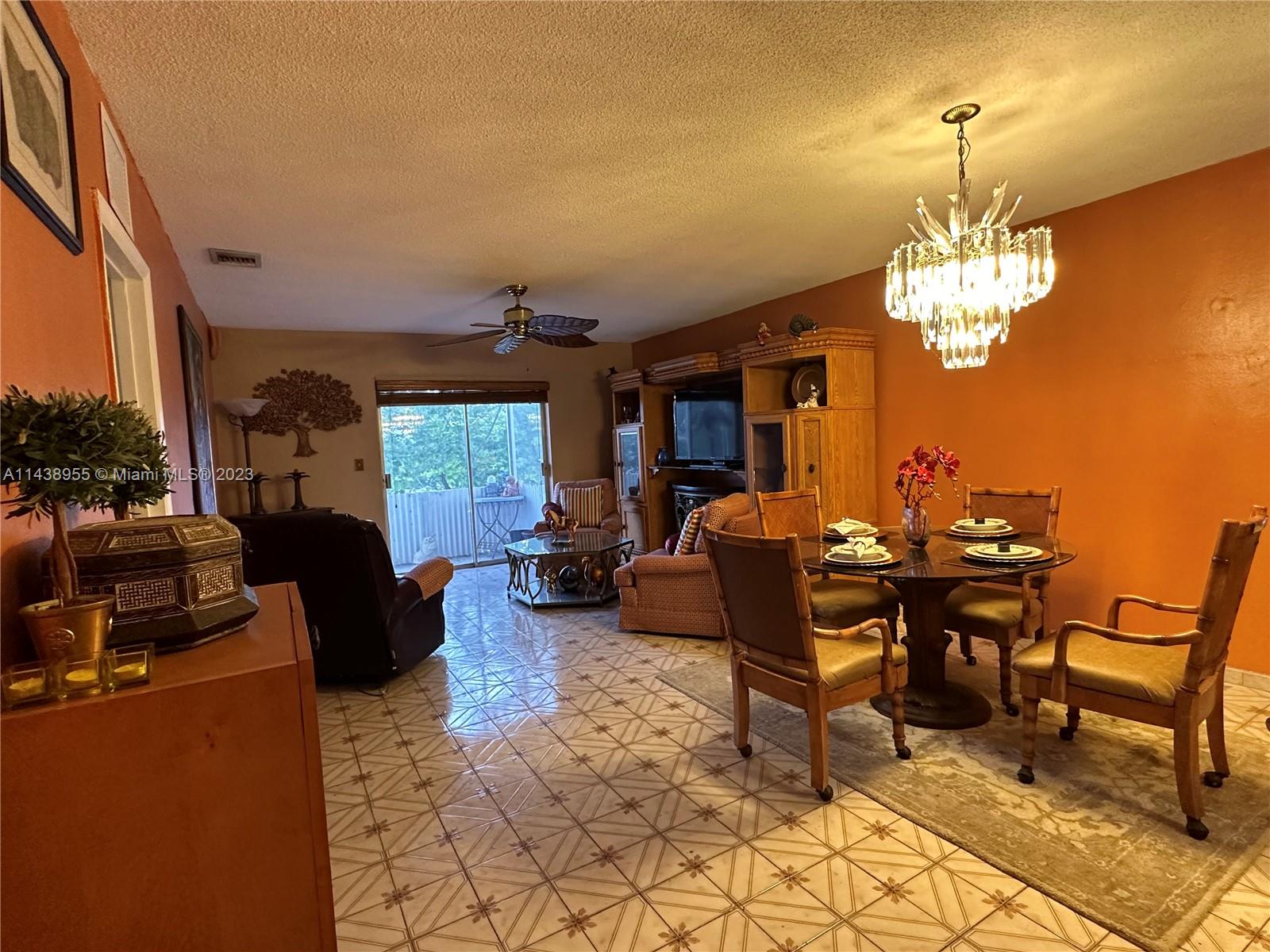 a view of a livingroom with furniture a rug and a chandelier