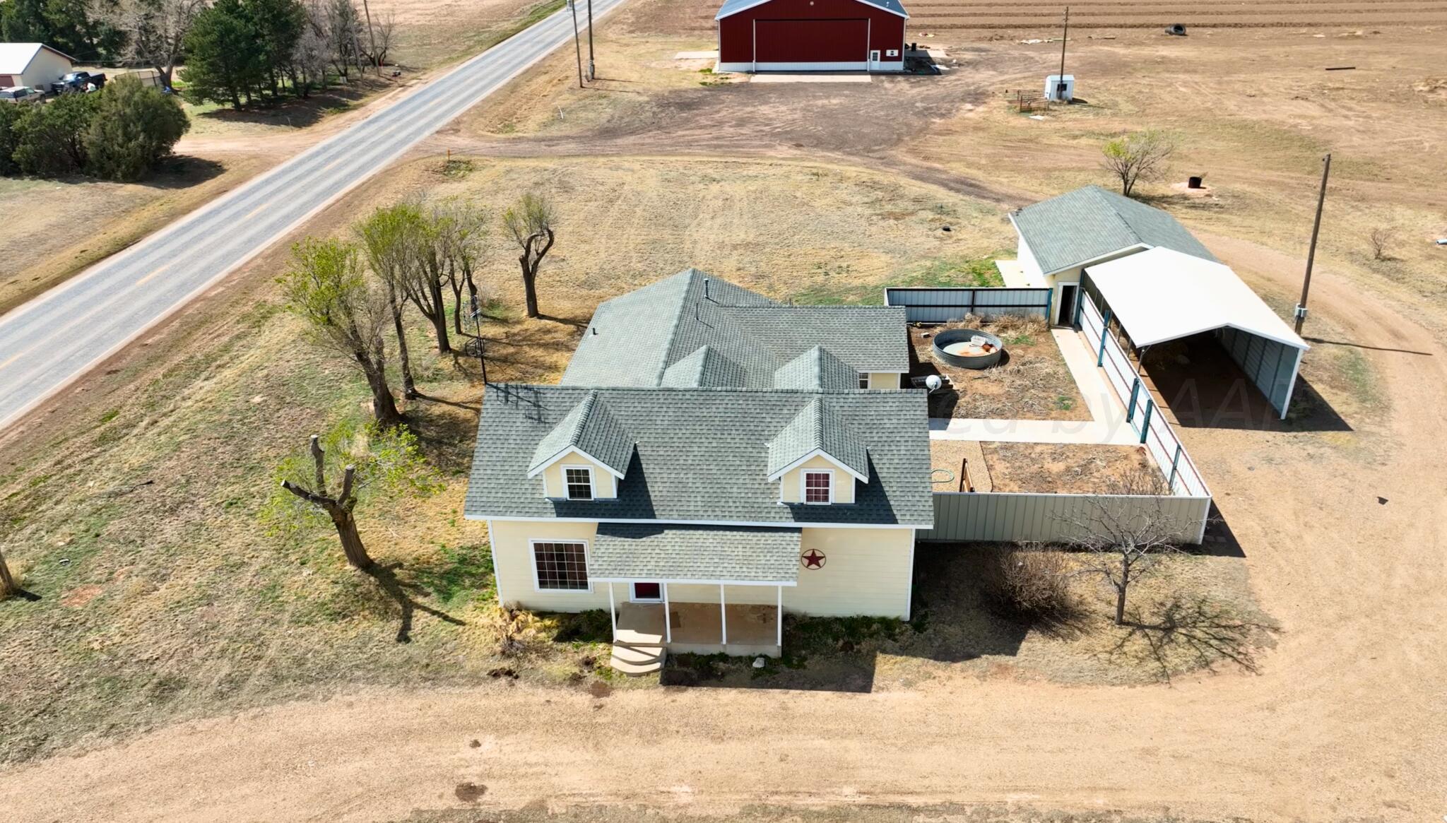 an aerial view of a house with a yard