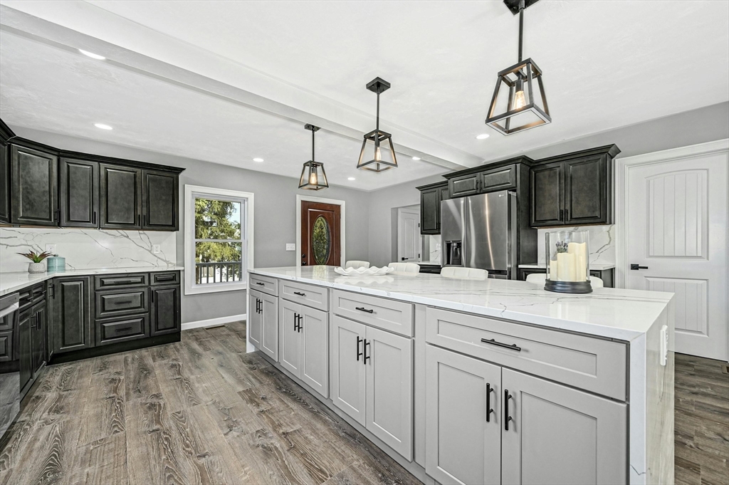 a kitchen with granite countertop a sink stainless steel appliances and cabinets