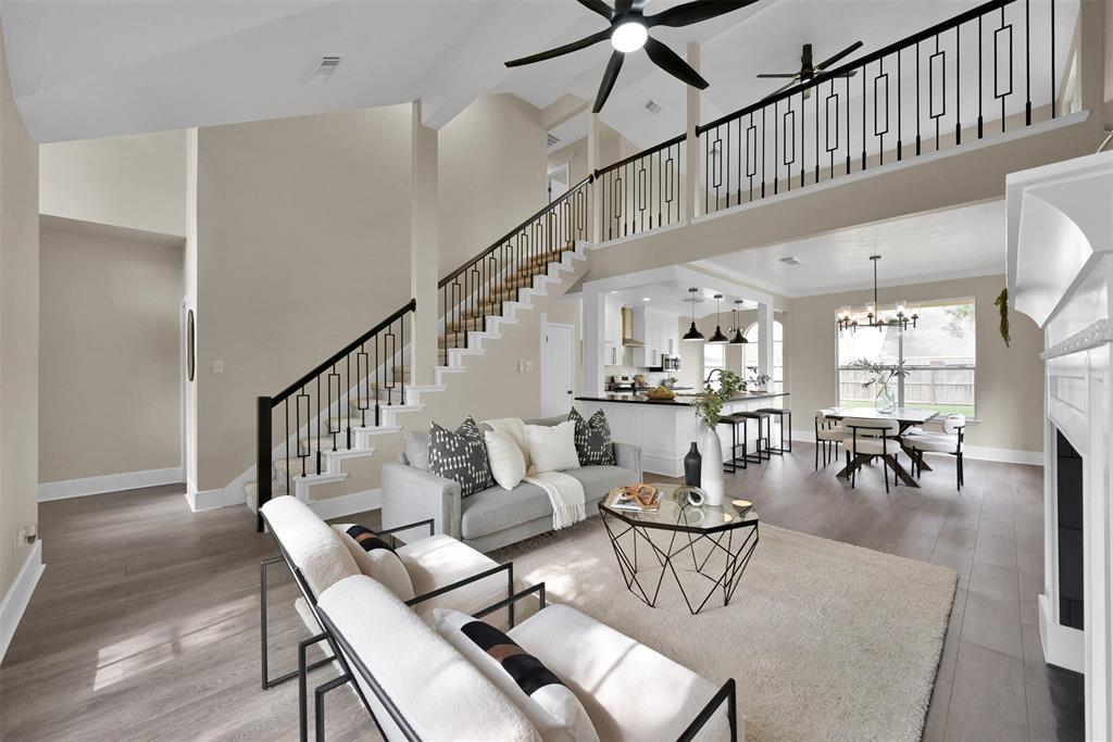 a living room with furniture a rug and a chandelier