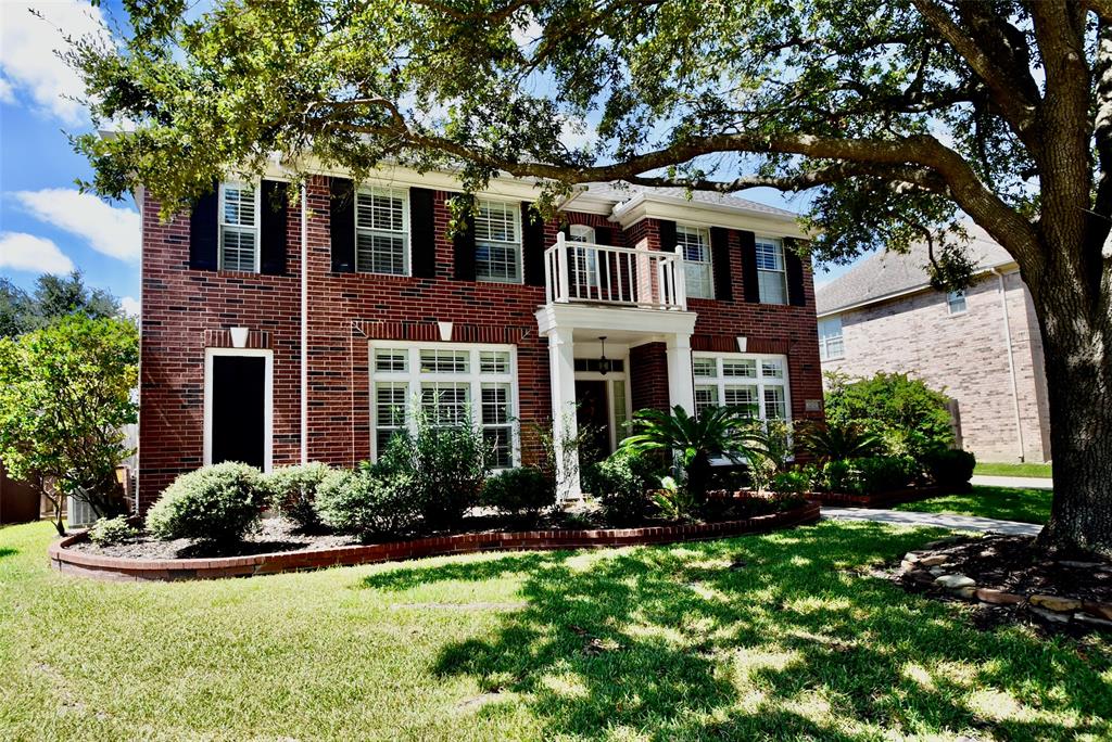 a front view of a house with yard and garage