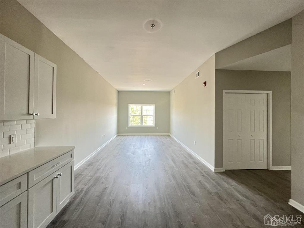 a view of a kitchen from a hallway