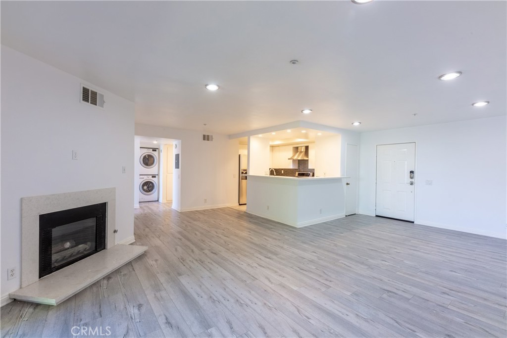 a view of a kitchen with a sink and a fireplace