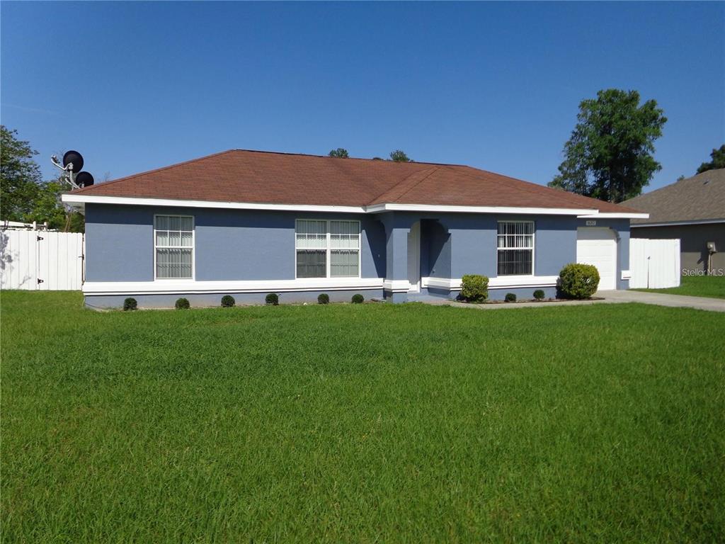 a front view of house with yard and green space