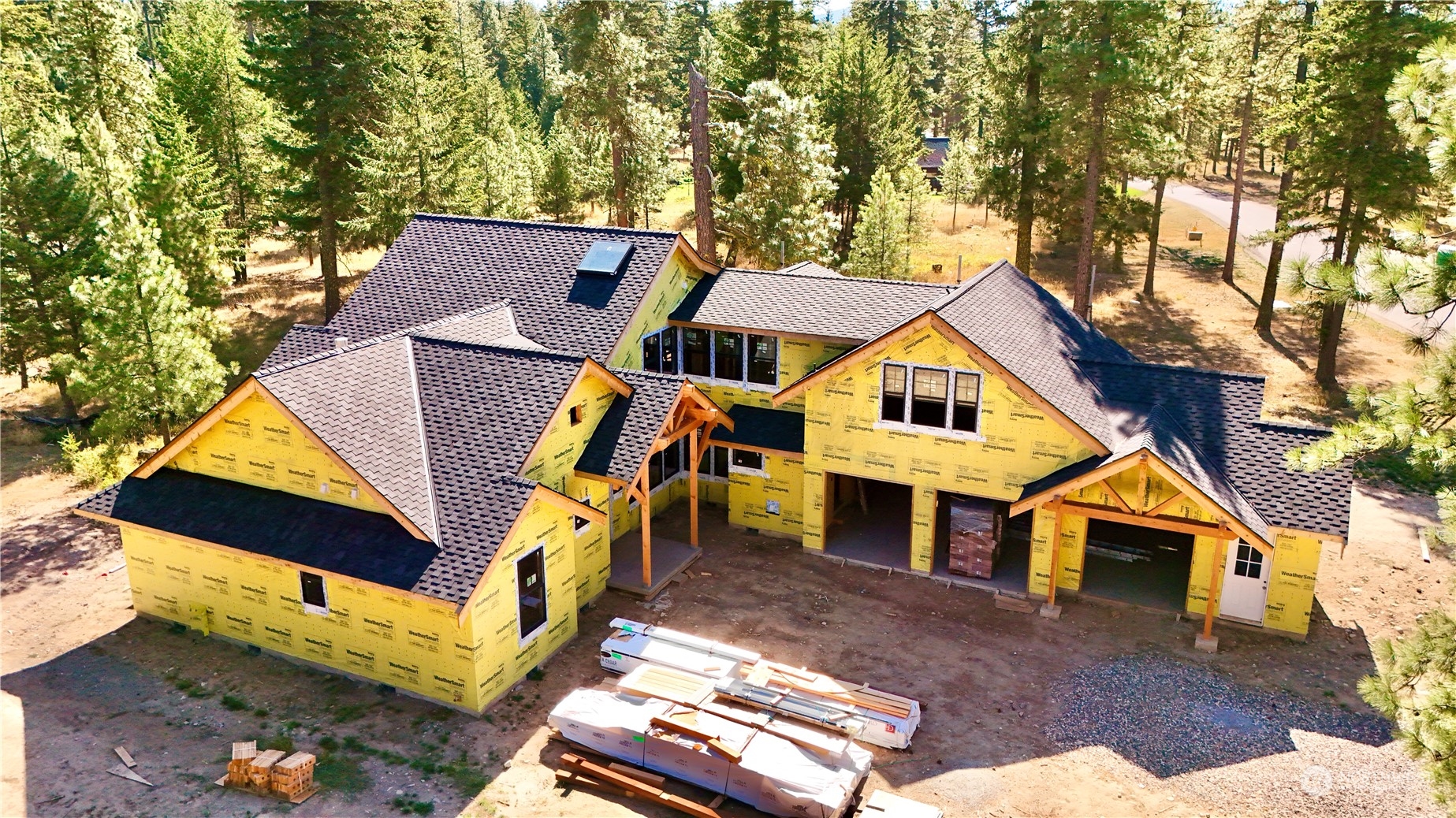 an aerial view of a house with a yard