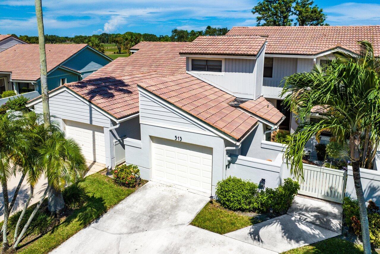 a aerial view of a house with a yard and potted plants